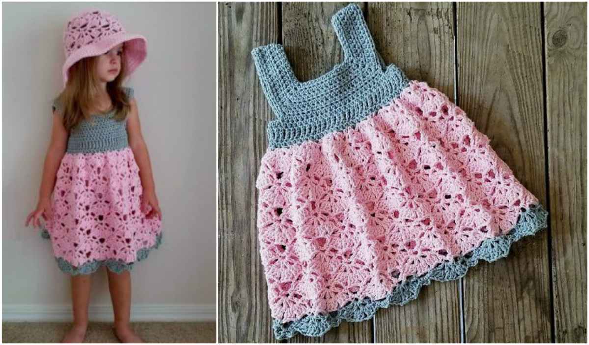 A child in a pink and gray crochet Falling Fans Dress with a matching sun hat poses happily, while nearby, the intricate crochet pattern of the dress is displayed beautifully on a wooden floor.