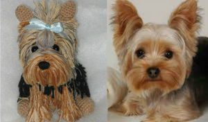A stuffed dog toy resembling a Yorkshire Terrier is displayed beside a real Yorkshire Terrier. Both have similar fur colors and styles, showcasing the charm of amigurumi craftsmanship.
