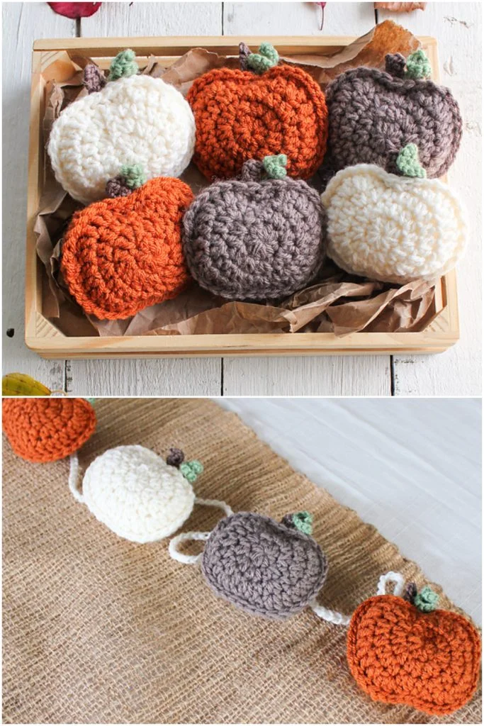 Crocheted pumpkins in orange, white, and grayโperfect as crochet decorations for fallโare displayed in a wooden tray and strung as a garland on a white surface.