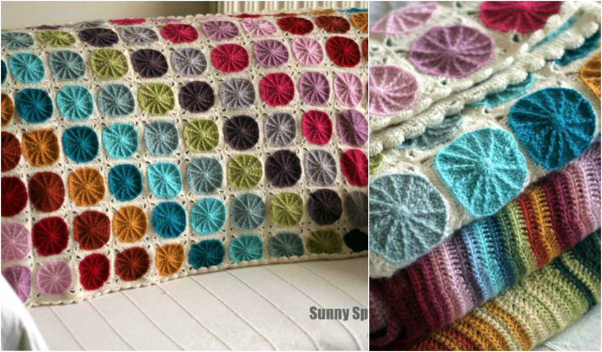 The Sunny Spread Blanket features vibrant circular patterns on a white background, elegantly folded and showcased on a pristine surface. This eye-catching design is perfect for those seeking a delightful crochet pattern to brighten up any space.