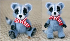 Meet Ms Raccoon Amigurumi—a delightful, plush raccoon toy with a charming red and white striped scarf. Perfectly sitting and standing on a beige surface, this adorable creation comes to life through a vibrant crochet pattern.