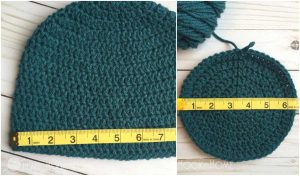 Crocheted teal beanie with a yellow measuring tape highlighting its dimensions.