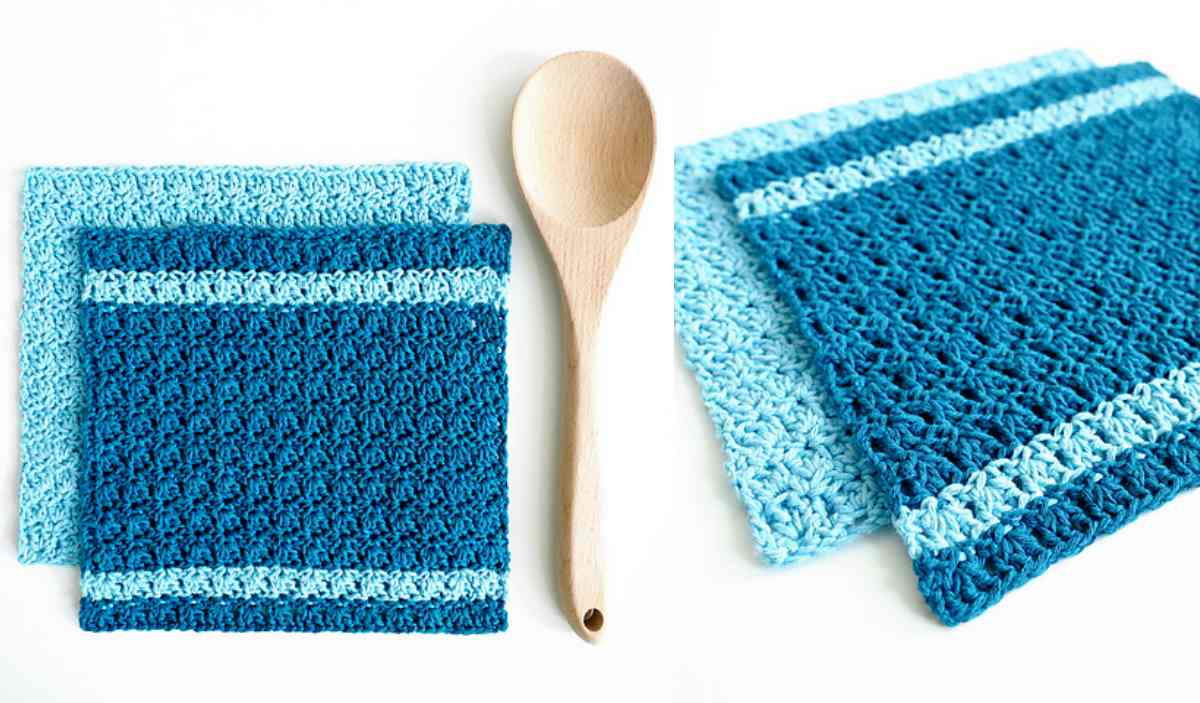 Two blue crocheted dishcloths, one with a stripe, next to a wooden spoon. Discover the Primrose Dishcloth crochet pattern for your next project.