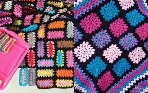 A colorful crochet mood blanket with various geometric patterns, including rectangles and squares, is partially covering a pink container holding extra crochet pieces.