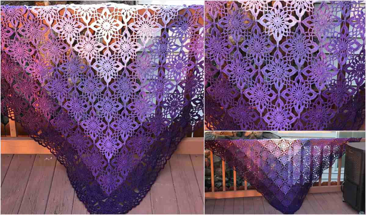 The Gypsy Queen Shawl, a crocheted triangular masterpiece in gradient hues of purple, is displayed on a wooden rail, showcasing a detailed floral crochet pattern.