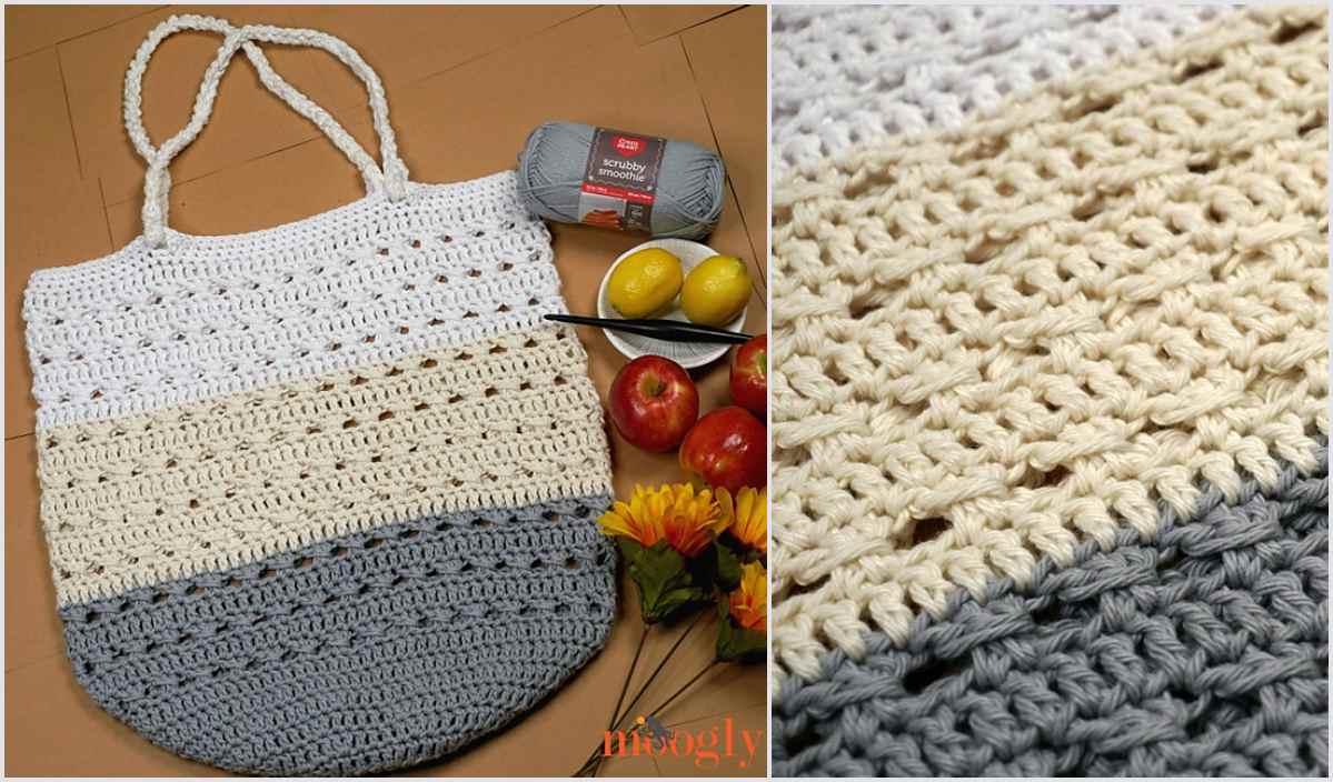 Crocheted tote bag with textured stripes in gray, beige, and white. Nearby are a crochet hook, yarn, apples, lemons, and a flower. Explore this market tote's charm with our free crochet pattern for your next project!