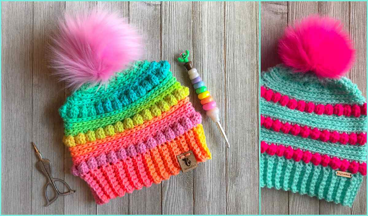 Two brightly colored knit hats with pink pom-poms sit beside a crochet hook and thread scissors. The left hat flaunts blue, green, orange, and pink stripes. Meanwhile, the turquoise and pink hat on the right is perfect for your next free crochet pattern project.