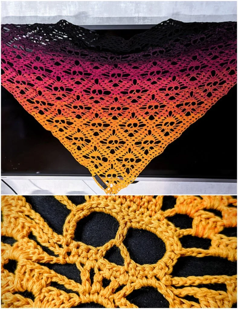 A triangular crochet shawl with a gradient from black to red to yellow, featuring a floral lace and subtle crochet skull pattern. Close-up shows intricate stitches, openwork details, and hints of edgy, skull-inspired motifs woven seamlessly into the design.