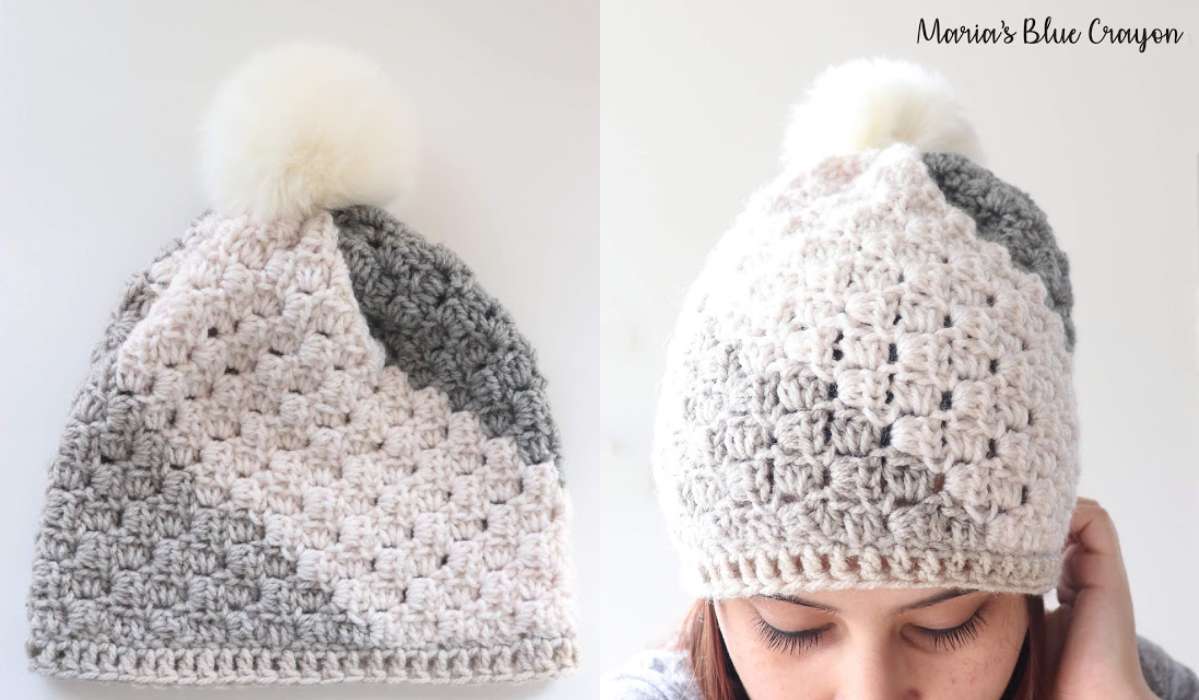 This charming C2C Beanie showcases a gray and white gradient pattern, complete with a fluffy white pom-pom. Displayed on a flat surface and modeled for a chic look, this stylish accessory is perfect for crochet enthusiasts seeking inspiration from an elegant crochet pattern.