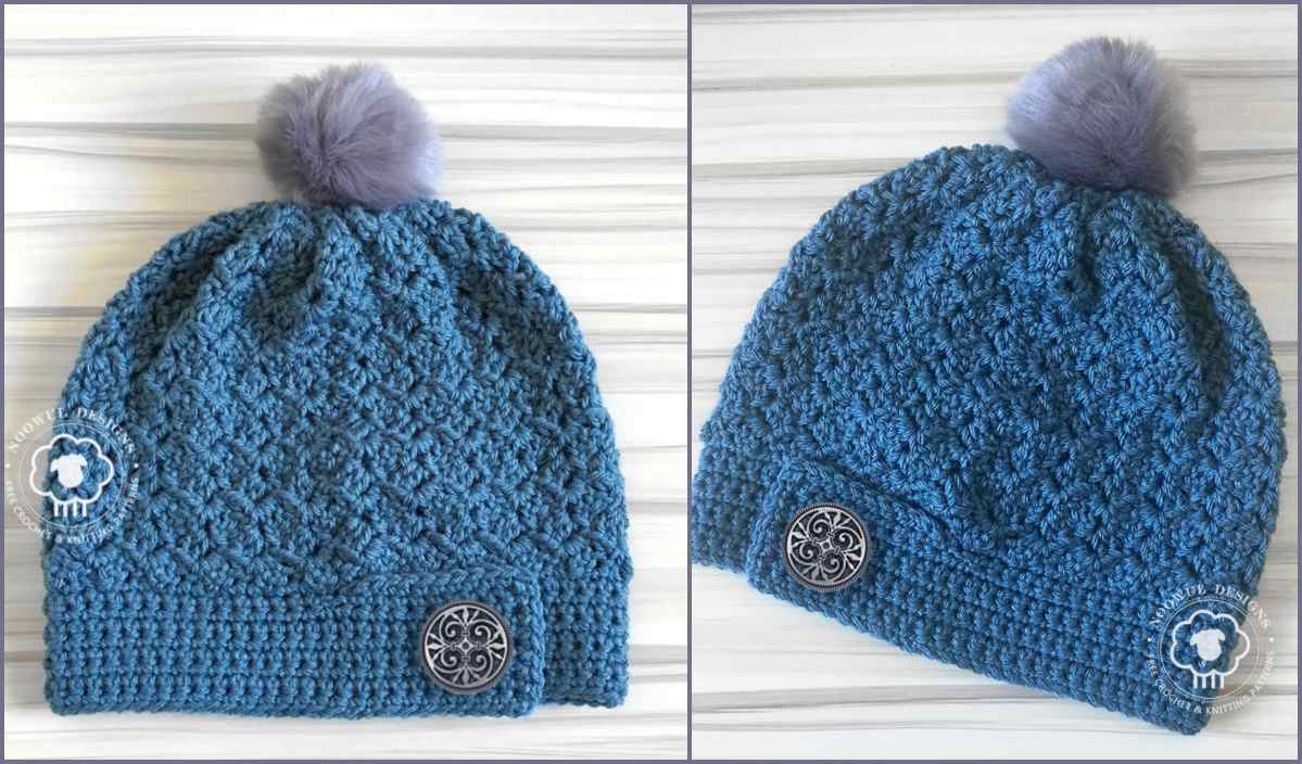 Two blue Faya Slouch crochet hats with textured patterns, each featuring a metal button and a fluffy pom-pom on top, are elegantly displayed on a light wood background. Perfect for those seeking a free crochet pattern to add flair to their winter wardrobe.