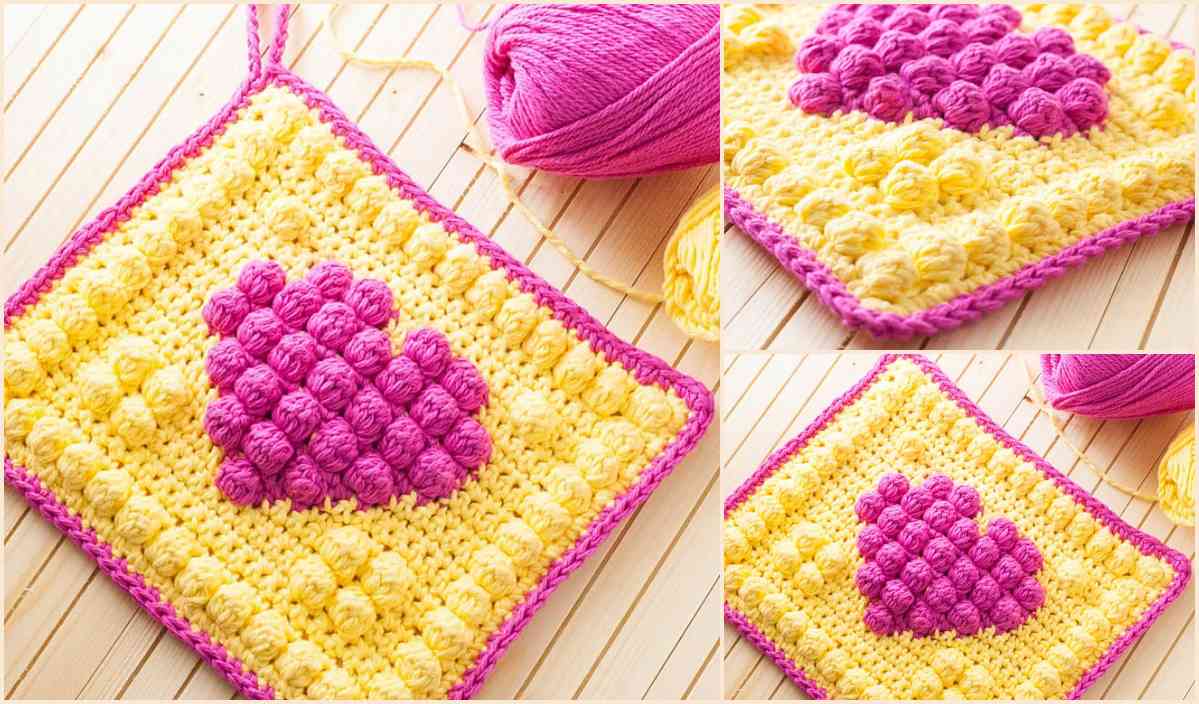 This crocheted square features a charming pink heart pattern centered on a vibrant yellow background, resembling the design found in free crochet patterns. Pink yarn is artfully strewn nearby, hinting at cotton face scrubbies in progress.