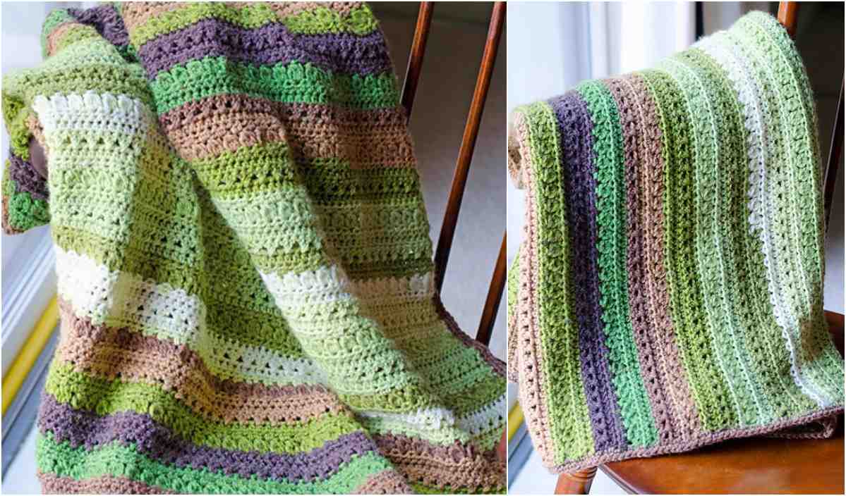 A crocheted baby blanket draped over a chair features green, brown, and cream stripes in a repeating pattern.