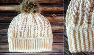 A cream-colored knit hat with a faux fur pom-pom sits elegantly on a wooden surface, showcasing both full and close-up details. This cozy accessory would pair perfectly with Blue Water Blankets for a chic and warm ensemble.
