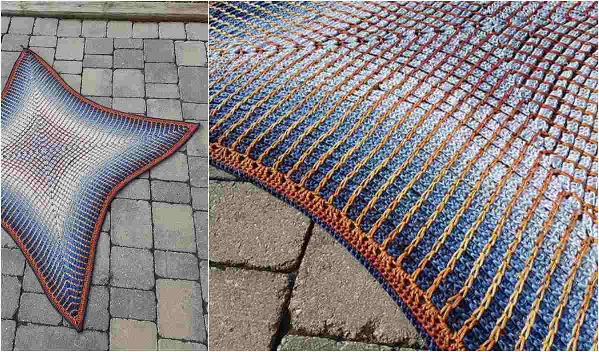 A multicolored crocheted blanket with a detailed texture is displayed on a stone-paved surface, showcasing intricate crochet hearts patterns in blue, orange, and white.