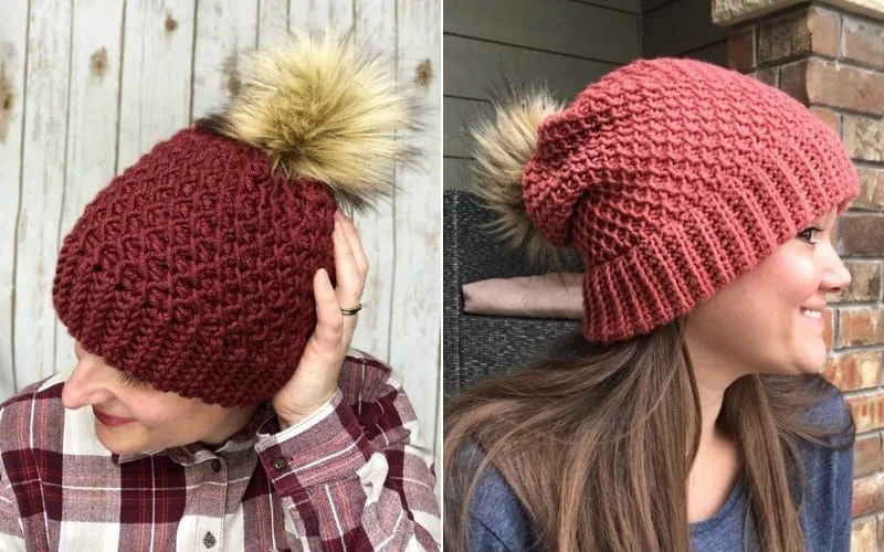 Two women wearing red beanies crafted with Tunisian crochet, each adorned with faux fur pom-poms. One pairs her stylish hat with a plaid shirt, while the other complements hers with a blue top.