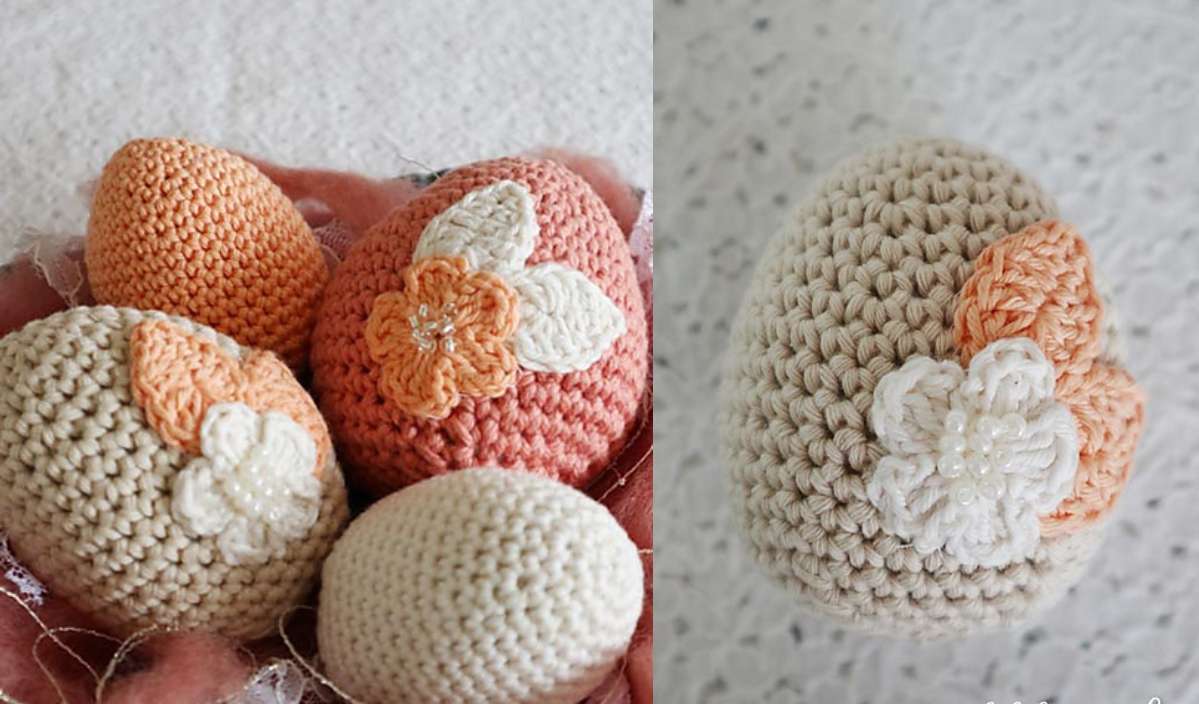 Four crocheted eggs in beige and peach with floral decorations, made using a delightful crochet pattern, are placed on a soft pink surface.