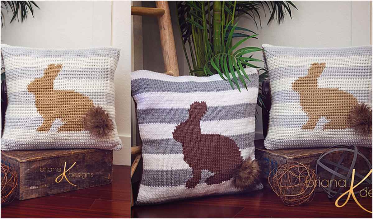 Two square pillows with intricate crochet rabbit designs, one in brown and the other in tan, are displayed on a wooden floor near greenery and decorative items. The cozy crochet pattern resembles the detail of a homemade poncho, adding warmth to any space.