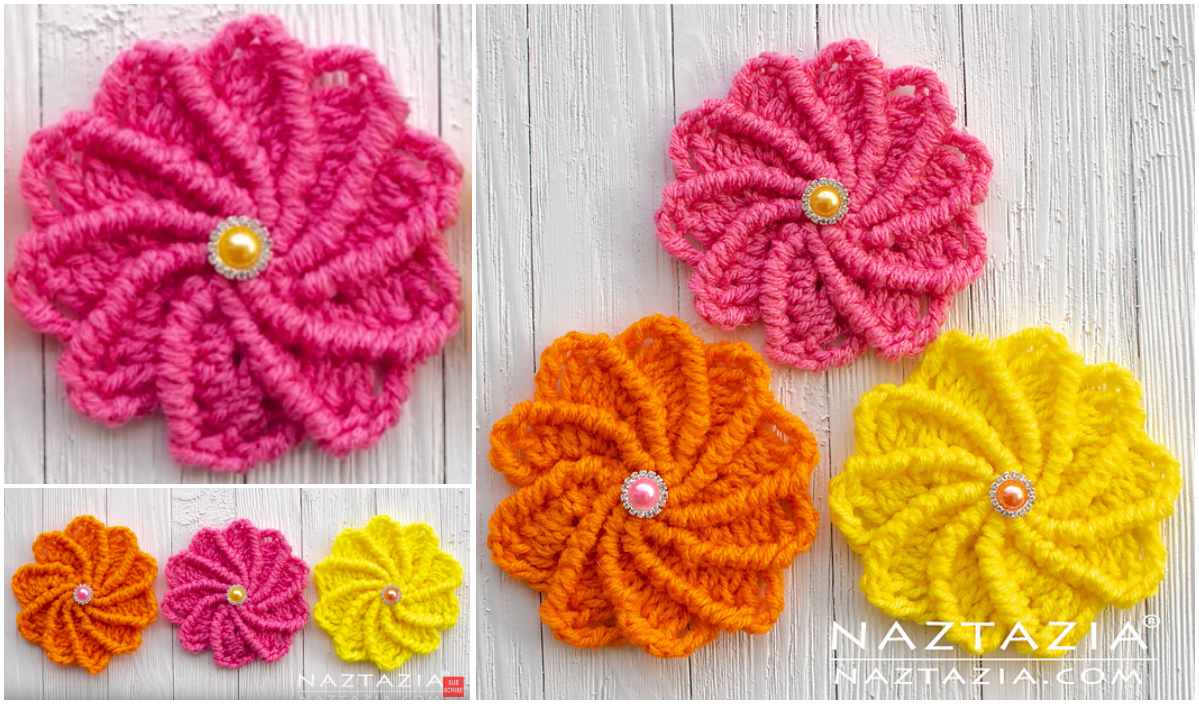 Three crocheted wheel flowers in pink, orange, and yellow with pearl centers are artfully arranged on a textured white surface. Perfect for those exploring crochet patterns, they capture the eye with their vibrant hues. Consider a video tutorial to bring these blooms to life at home.