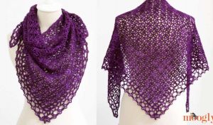 A mannequin showcases the elegant Fortune’s Shawlette, a deep purple crocheted triangular shawl with a lacy pattern, beautifully captured from two angles.