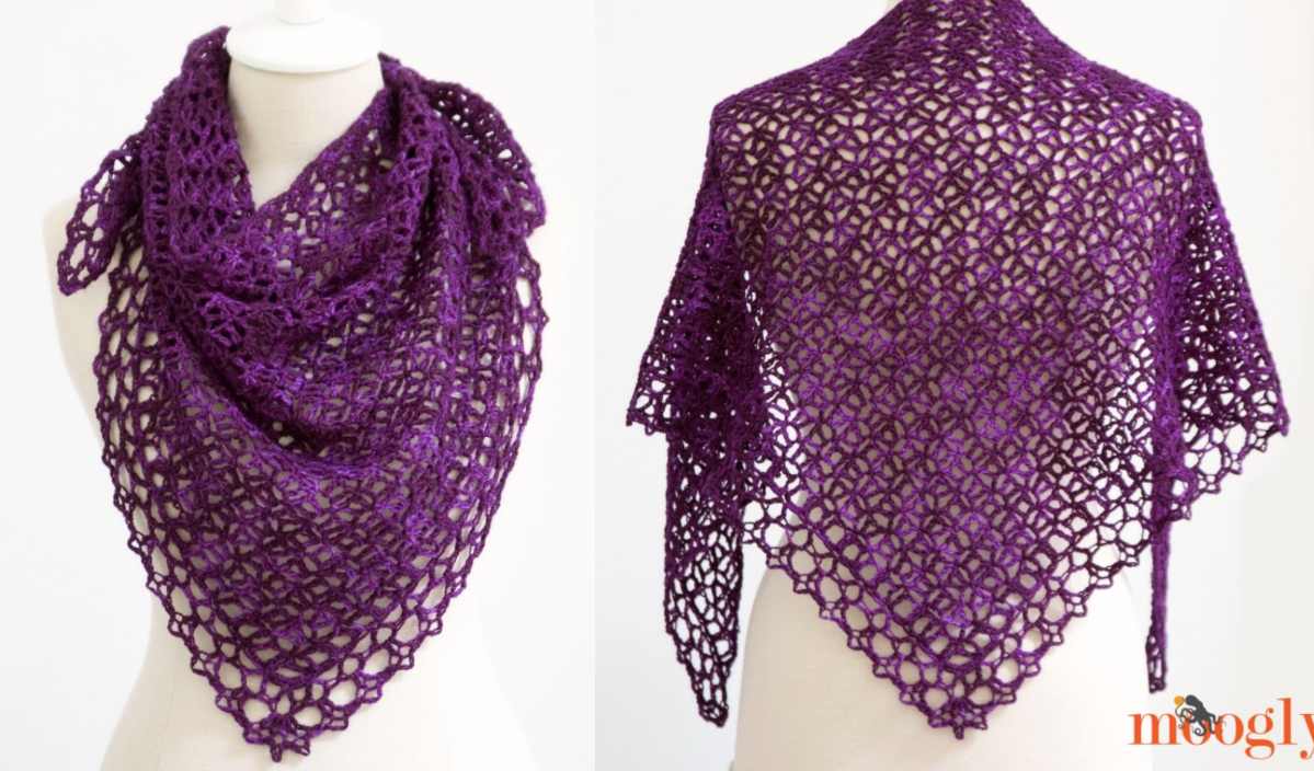 A mannequin showcases the elegant Fortune’s Shawlette, a deep purple crocheted triangular shawl with a lacy pattern, beautifully captured from two angles.