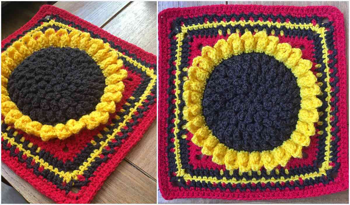 Two colorful crocheted sunflower squares, boasting a large brown center and vibrant yellow petals, stand out against a rich red and black patterned background. Discover the charm of this beautiful crochet pattern.