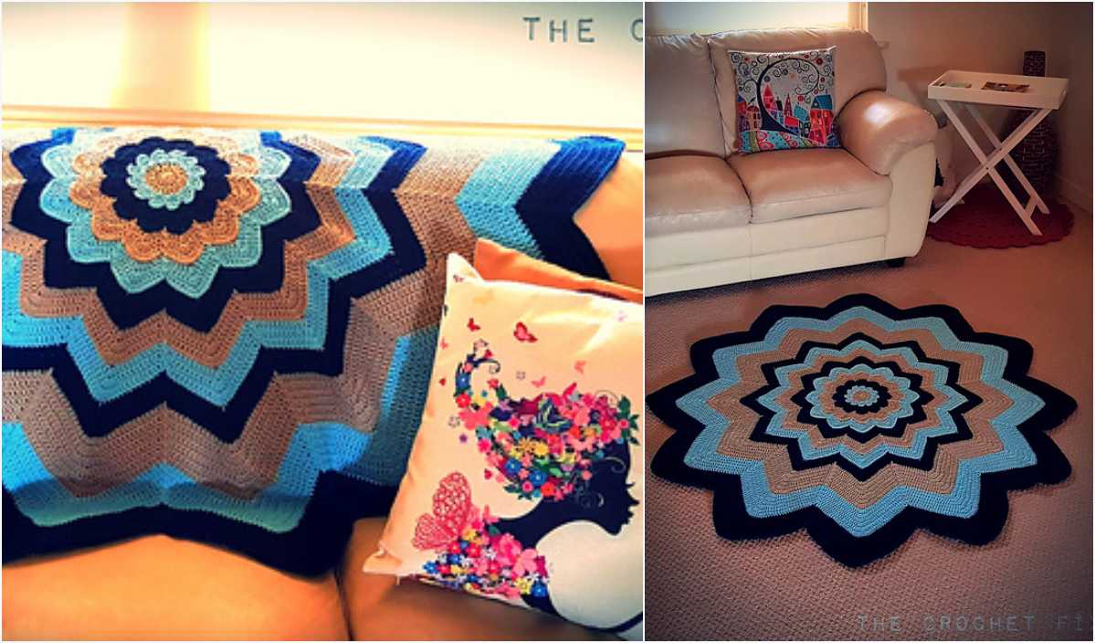 A living room with a beige couch draped with a flower crochet blanket, featuring intricate blue and brown patterns. A colorful pillow complements the theme, resting above a matching crocheted rug on the floor.