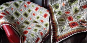 A Retro Squares Blanket with green, orange, and cream geometric patterns is draped over a red chair. The close-up highlights the detailed stitching and color transitions, evoking a nostalgic vibe. Consider crafting your own with the free crochet pattern!