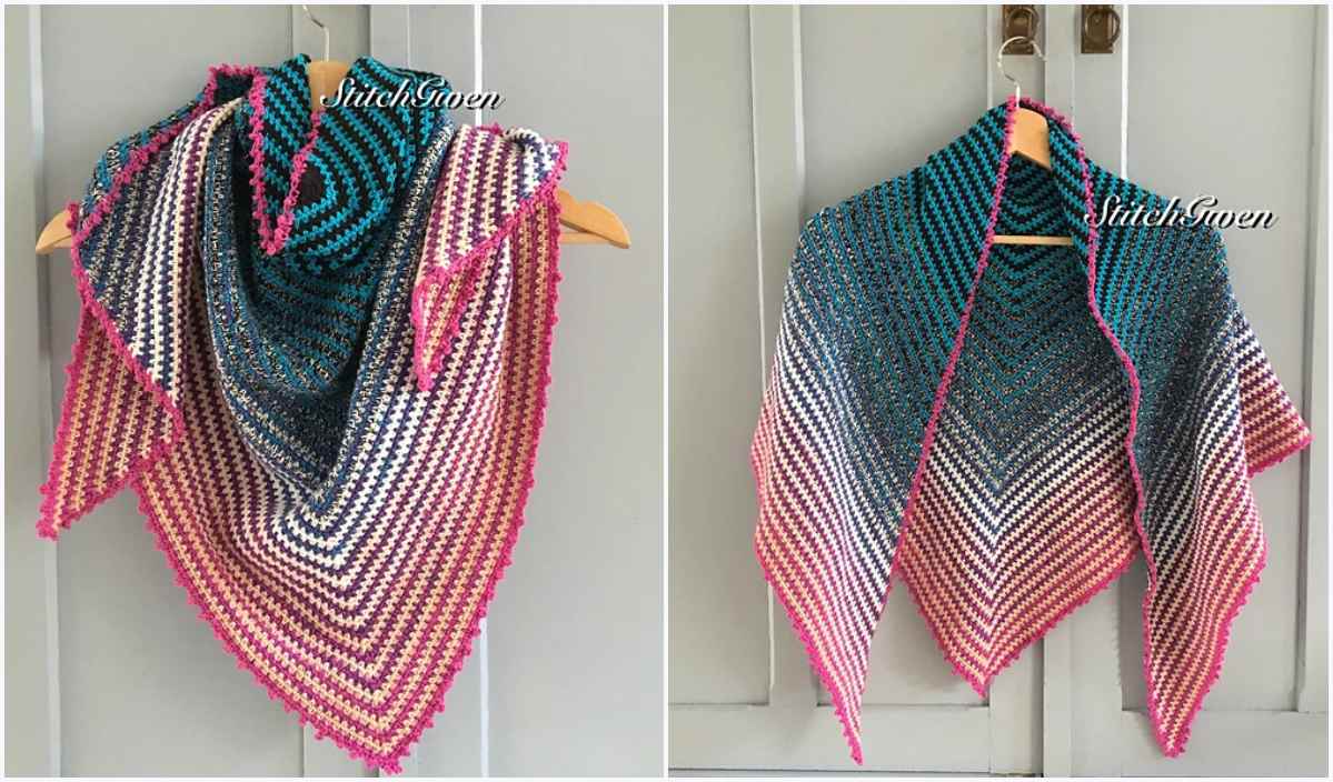 Two crochet shawls with multicolored patterns, reminiscent of vibrant flower crochet blankets, are edged in pink and hang on a hanger against a light gray background.