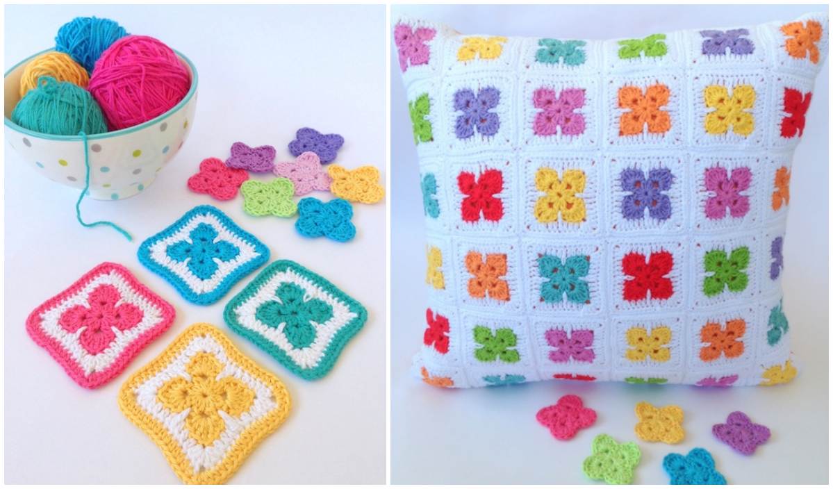 A vibrant crochet pillow adorned with colorful flower squares sits next to a bowl of multicolored yarn, accompanied by scattered crochet squares. Discover the inspiration from our free crochet pattern and create your own stunning Fleur Afghan masterpiece.