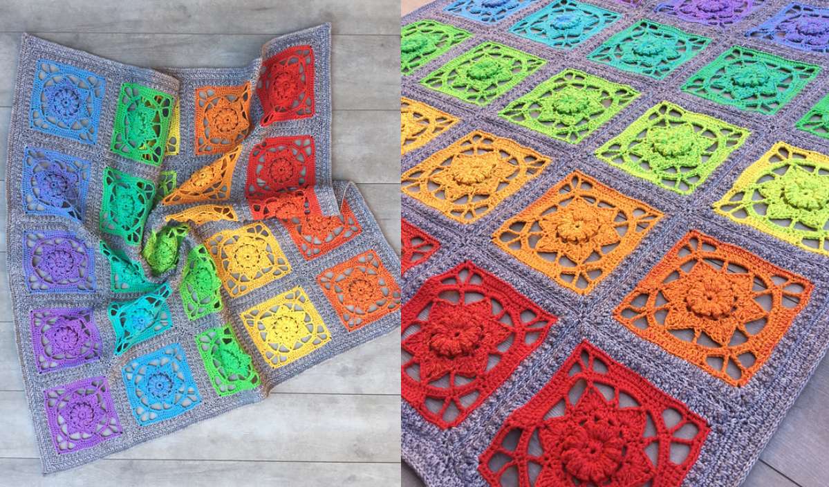 The crocheted blanket, inspired by the "Jeanette at Sunset" theme, showcases colorful square patterns in rainbow hues, each featuring a detailed, flower-like motif. This vibrant creation is artfully displayed on a wooden floor.