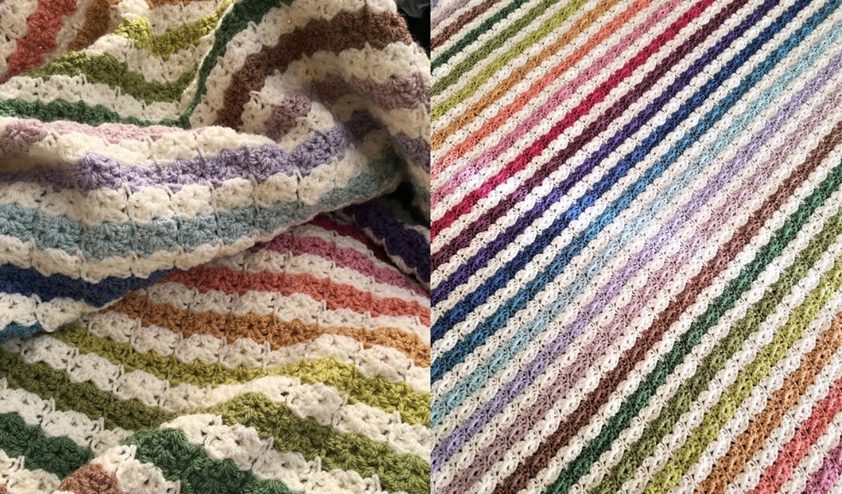 A crochet blanket with multicolored stripes, featuring a scalloped pattern in various pastel shades, resembles the delicate artistry of a free crochet pattern.