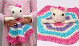 The child clutches a Kitty Lovey, a crocheted cat-shaped security blanket in a vibrant pink, purple, and blue pattern. A close-up on the right reveals the intricate crochet pattern laid flat.