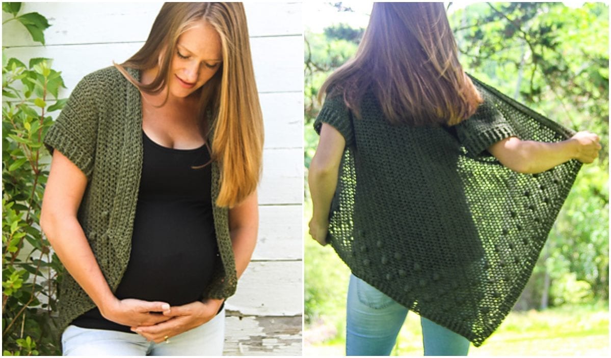 A pregnant woman stands outside showcasing the elegant Olivia Cardigan, skillfully crafted from a free crochet pattern. Wearing a black top beneath, she displays the green knitted design from both the front and back.