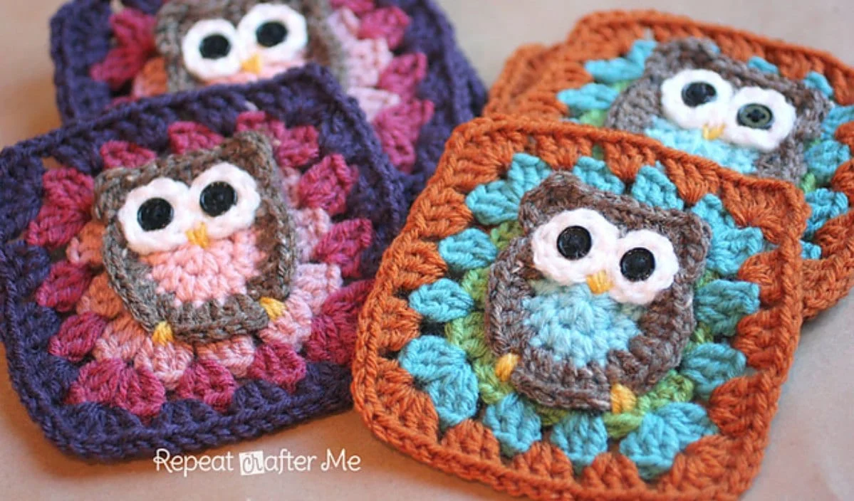 Crocheted owl granny squares in various colors are artfully arranged on a surface, showcasing a delightful and whimsical free crochet pattern.