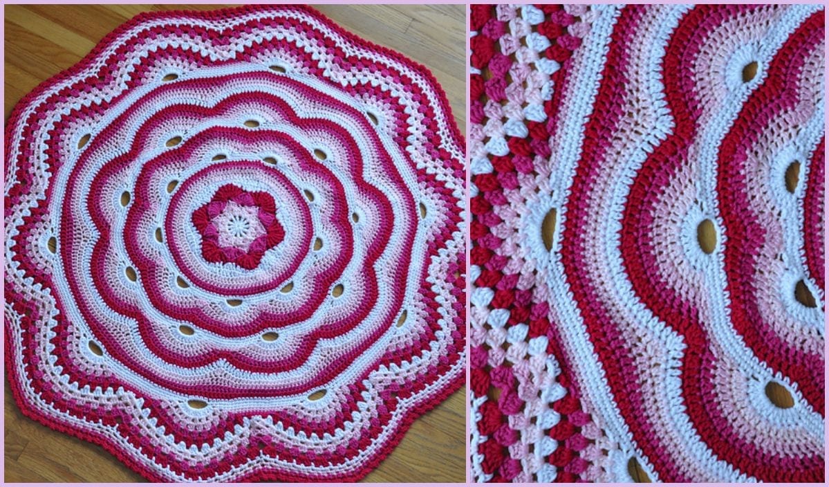 Round crochet blanket with red, pink, and white concentric wave-like patterns. The close-up reveals intricate stitches reminiscent of the artistry found in a free crochet pattern, showcasing vibrant craftsmanship.