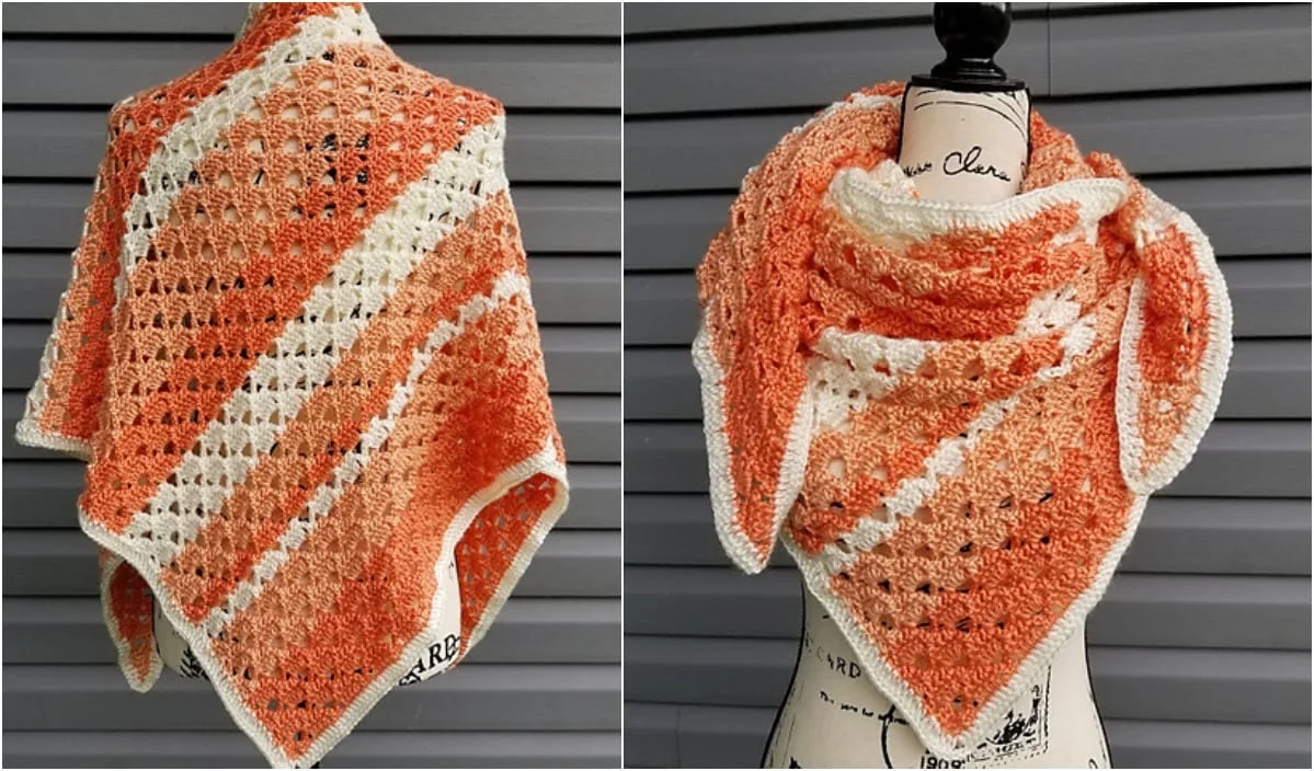 The Melon Ball Shawl, an orange and white crocheted wonder, graces a mannequin against a gray backdrop. This piece showcases a triangular pattern with exquisite textured details, perfect for those seeking a unique free crochet pattern.