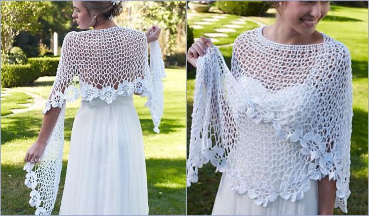 A woman wearing a white bridal shawl with intricate floral crochet patterns over a white dress stands gracefully on a green lawn.