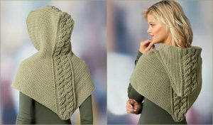 A person is wearing a green knitted hooded shawl with a cable knit design on the back and sides, reminiscent of a cabled hooded cowl. The stylish piece could easily be created using a free crochet pattern. Front and back views are shown.