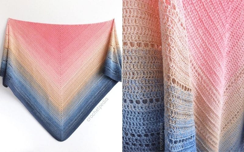 Introducing the Lake Sunset Shawl, a crocheted triangular masterpiece featuring a stunning gradient from pink to beige to blue. The close-up reveals intricate stitch patterns, perfect for those seeking inspiration. For more creative ideas, explore our free tutorial.