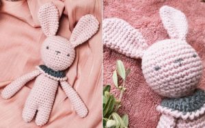 Crocheted Rose Bunny Amigurumi with a dark collar, showcased on a pink fabric background, featuring exquisite close-up detailing.