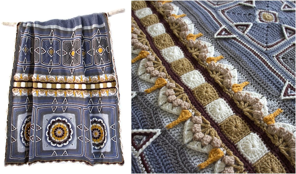 A multicolored crochet blanket with intricate geometric and floral patterns in blue, white, brown, and yellow hues is displayed on a wooden rod. This Summer and Fall Blanket boasts a close-up view showcasing the detailed texture and stitching, perfect for crochet enthusiasts.