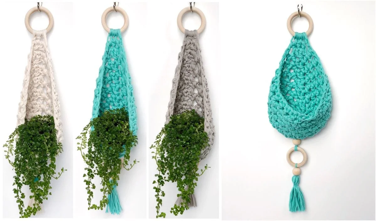 Four crocheted plant hangers, crafted with intricate crochet patterns, cradle trailing green plants. They feature wooden rings and beads and come in white, teal, and grey with a charming tassel finish.