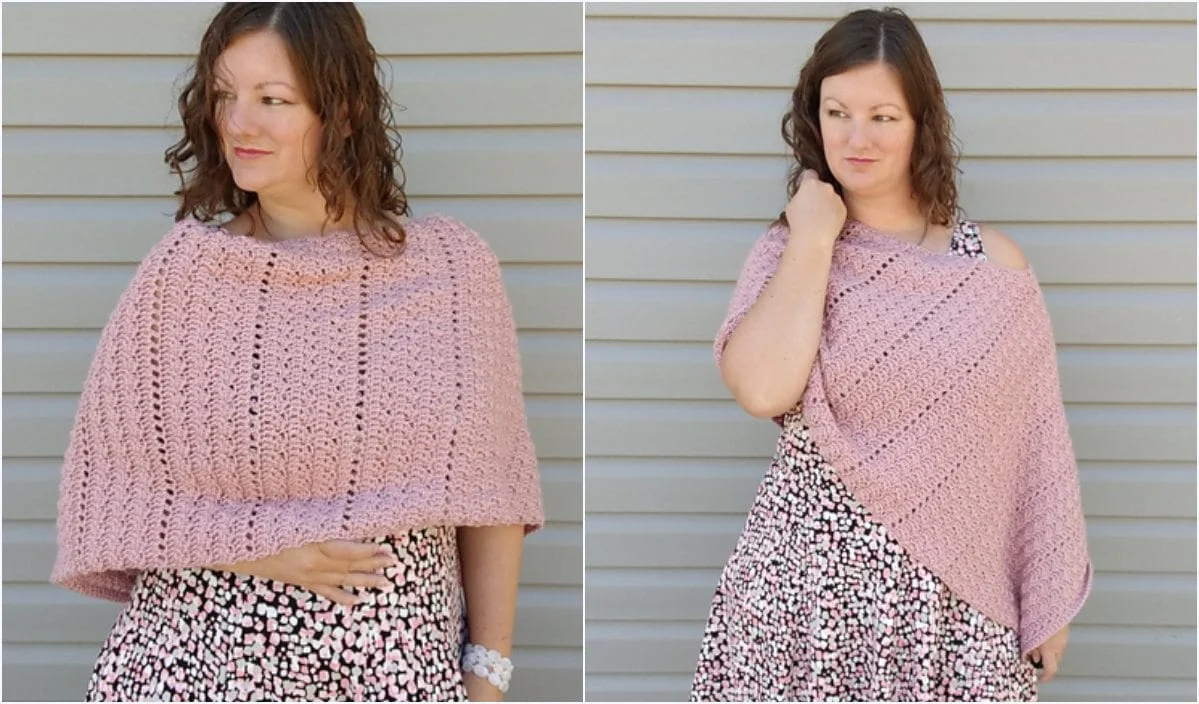 A woman wearing a pink knitted poncho, reminiscent of a Sleepy Bunny, stands gracefully against a horizontal siding background, her ensemble completed with a patterned skirt that showcases intricate crochet patterns.