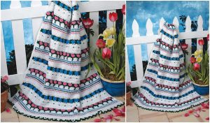 Draped over a white picket fence, this handmade baby blanket boasts floral and striped patterns in pink, green, blue, and white. Surrounded by potted tulips and greenery, it’s a delightful nod to flower motifs. Enjoy crafting your own with free crochet patterns!