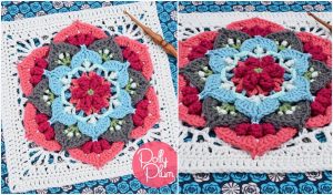 A colorful crocheted square with a mandala pattern featuring pink, blue, gray, and green rests on a patterned fabric background. A wooden crochet hook suggests the start of a new project like a chain loop circle scarf or experimenting with a free crochet pattern.
