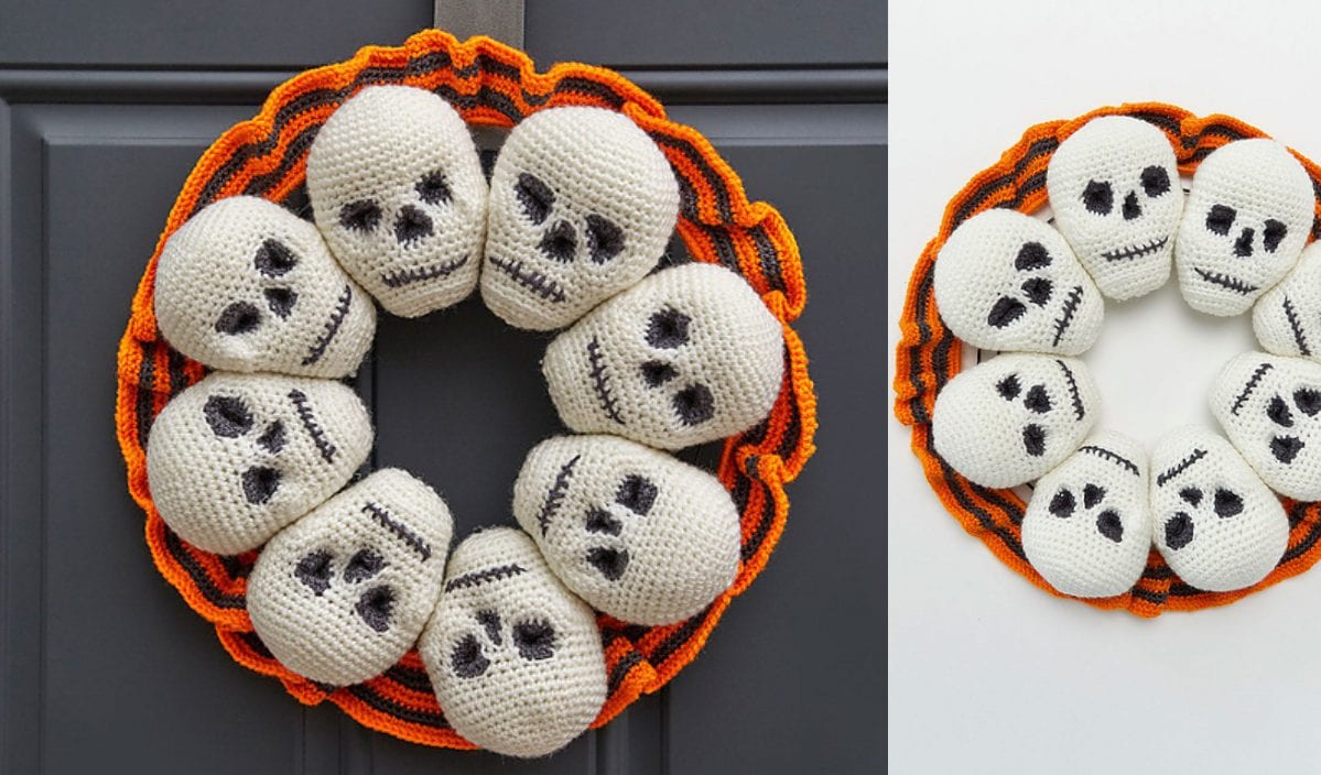 A crocheted Halloween wreath, showcasing eight skulls with black facial features against a striped orange and black backdrop, elegantly adorns a door and white surface, embodying the spirit of Halloween decor.