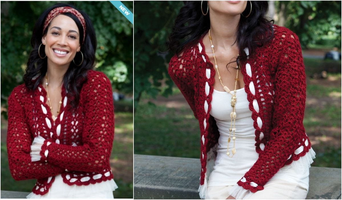 A woman, draped in an elegant red and white knit cardigan over a white top, with a headband and hoop earrings, smiles outdoors.