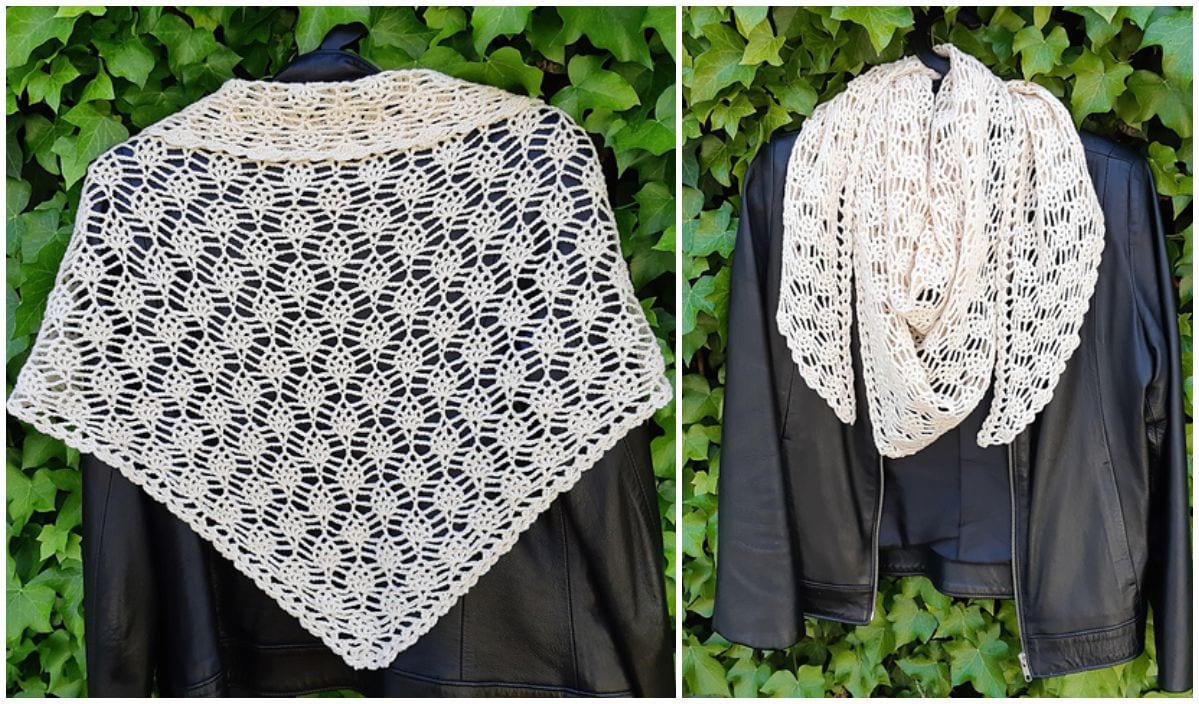 A crochet lace shawl, reminiscent of a Pineapple Wrap, graces a black leather jacket against a lush green ivy backdrop.