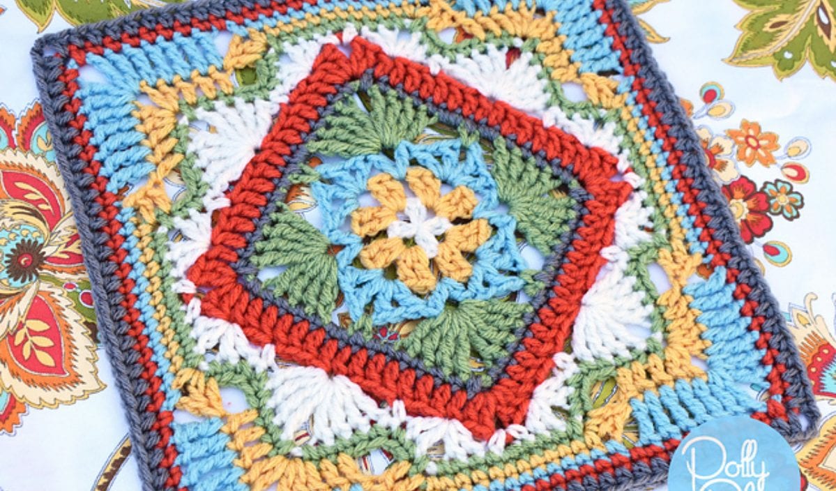 A vibrant crocheted square showcasing intricate crochet patterns in red, blue, green, white, and yellow on a floral background.