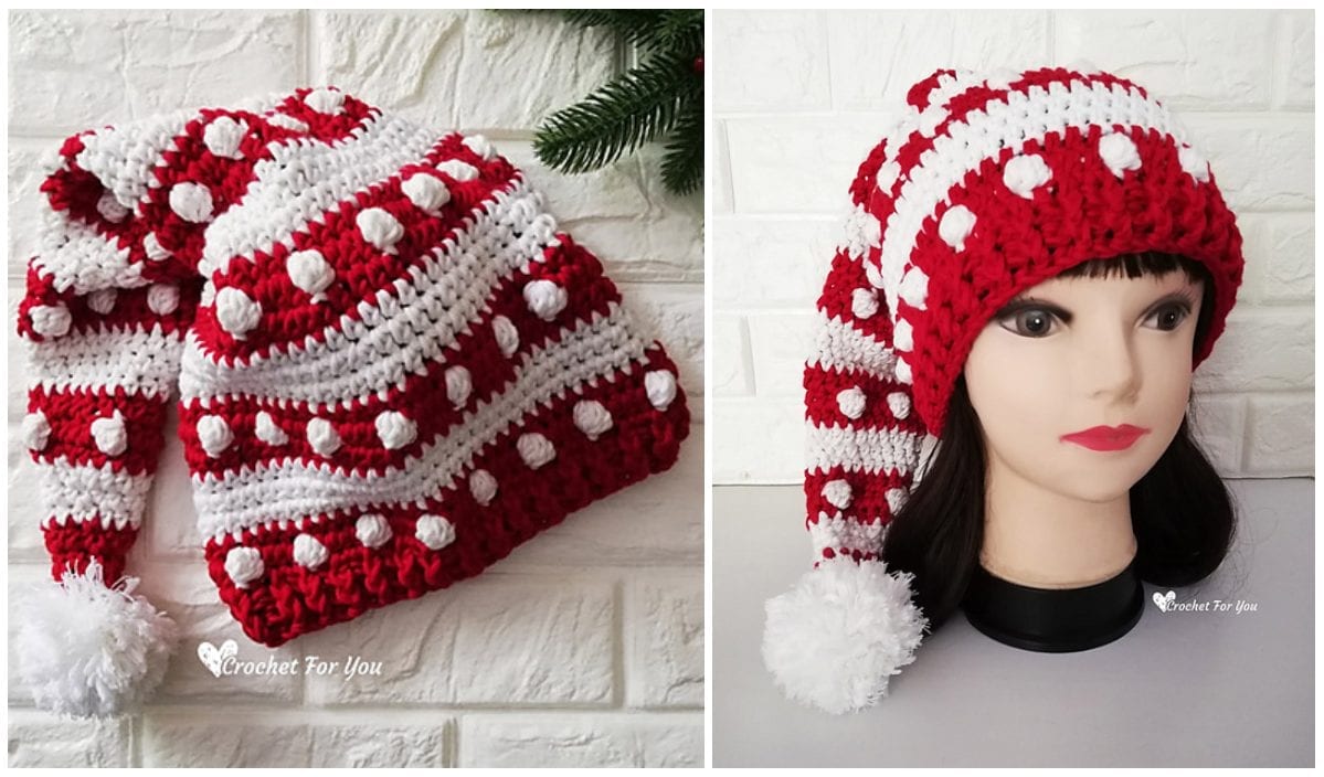 Red and white crochet hat with pom-poms shown on a table and on a mannequin head, reminiscent of a playful Baby Yoda design.